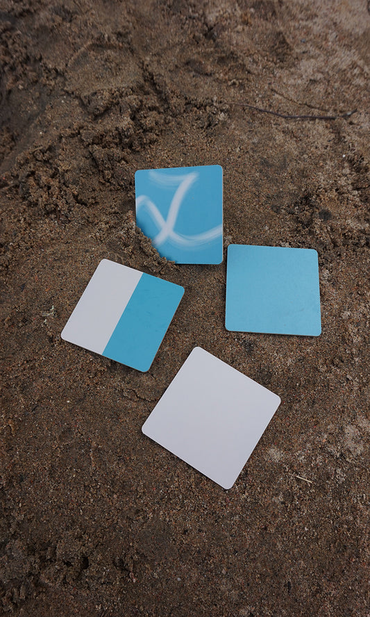 Glasunderlägg i mixade färger från Jenilin på strand